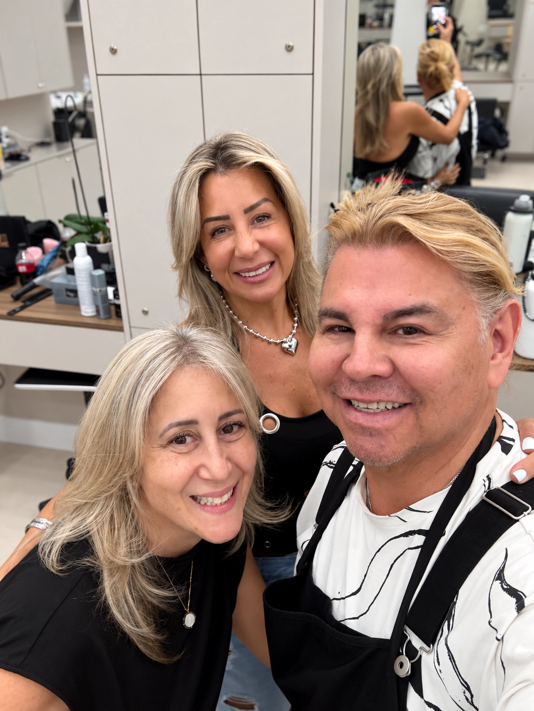 George with two clients in the salon