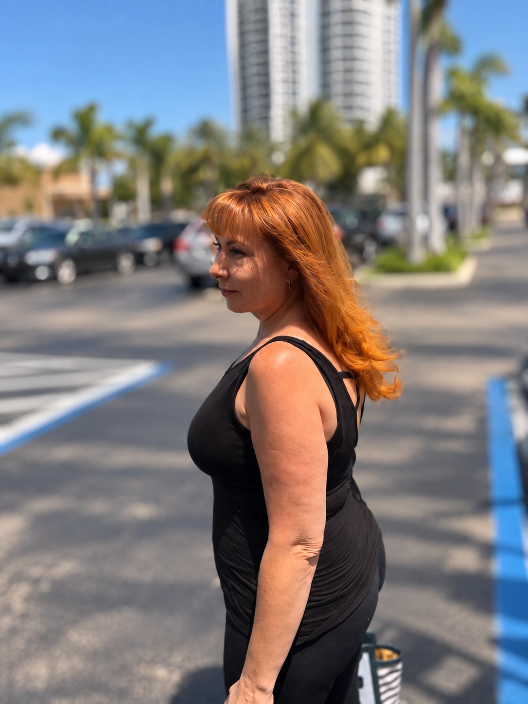 A client with copper hair outdoors in Miami